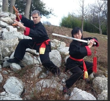 Sun Qi Fitness founders Min Min and John Valenti practicing martial arts outdoors